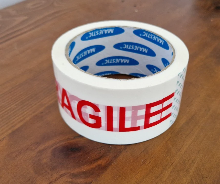 One roll of red and white fragile packaging tape